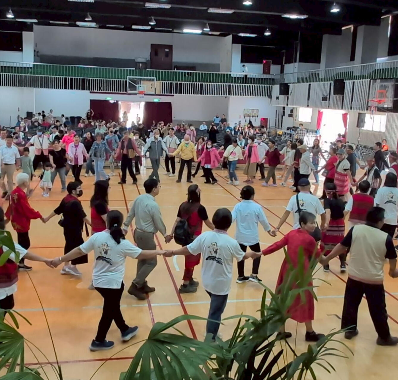 Photo of people dancing in a circle singing Aiyan